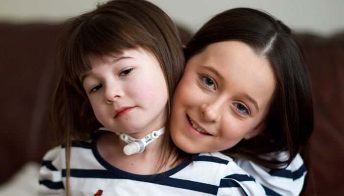Photograph of Ellie at home with her family Photograph for charity of child with genetic disorder