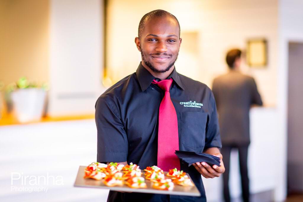 Event Excel London Photography of waiter offering plate of food