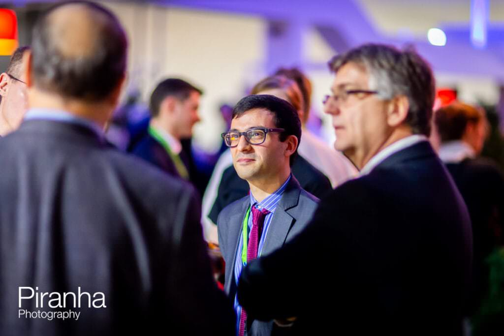 Excel event photography of stand in London with guests mingling
