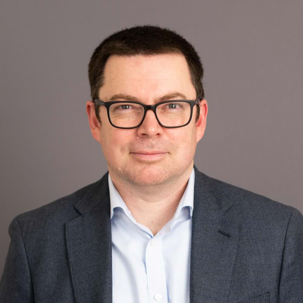 Headshot photograph against grey backdrop taken at Oxford Science Park