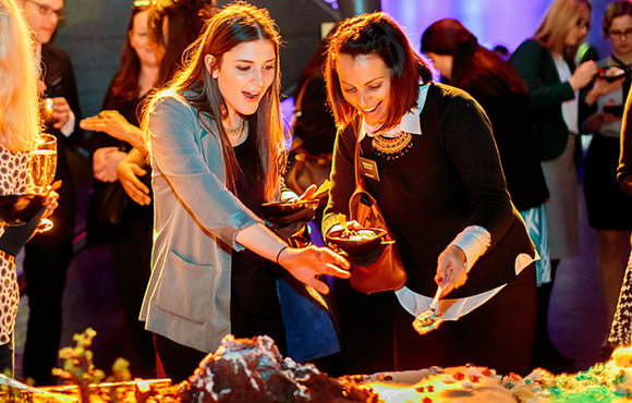 Guests photographed helping themselves to food at Natural History Museum event in London