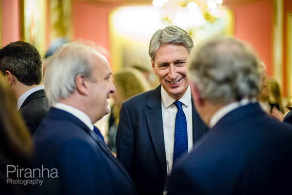 Photograph of Philip Hammond, Chancellor of the Exchequer at evening event Philip Hammond with guests at evening event at In & Out Club