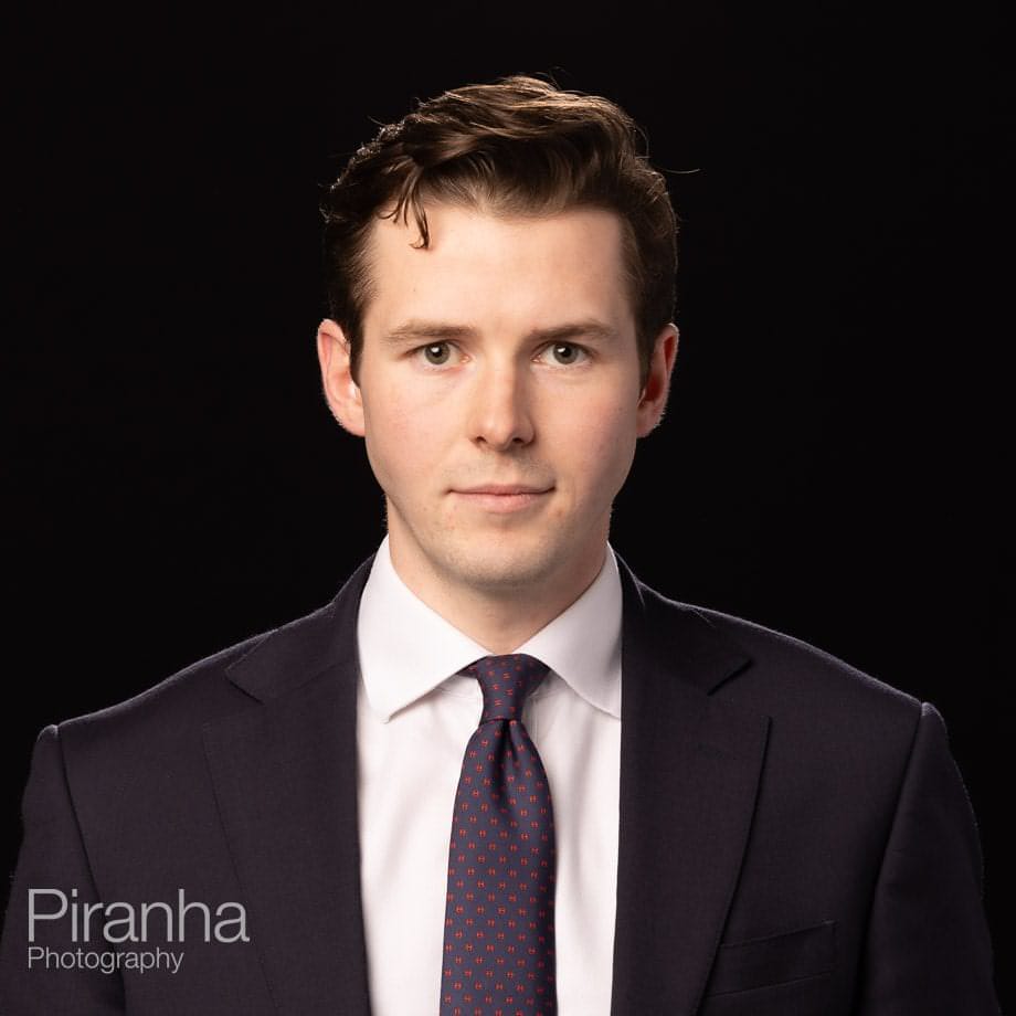 Headshots taken against a black background back drop.