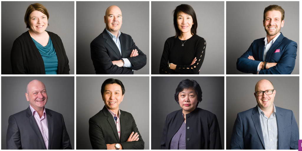 Headshots of employees on grey background