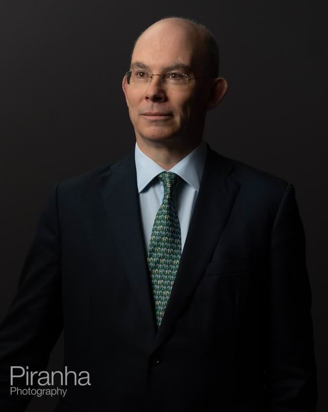 Headshot photography against grey backdrop.