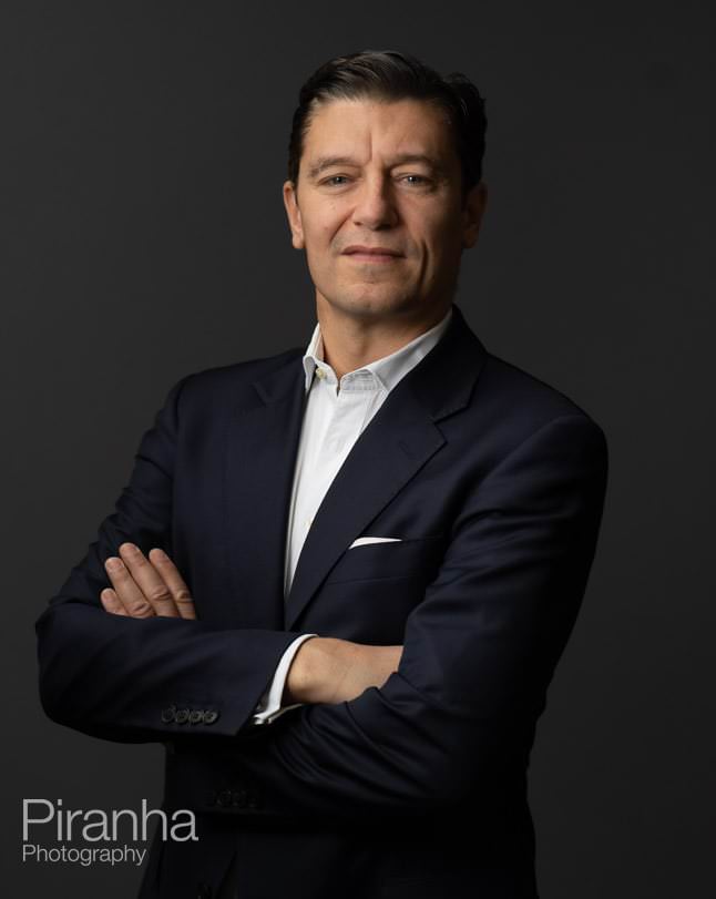 Headshot photography against grey backdrop.