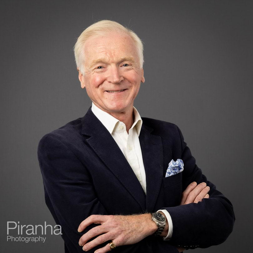 Corporate portrait photograph taken with grey background.