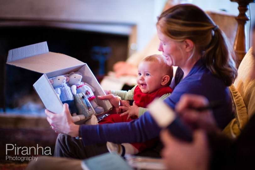 Photograph of Christmas present opening and baby's expression of delight
