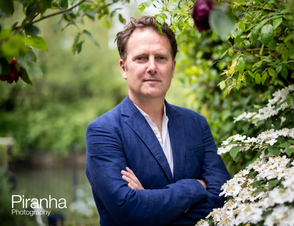 Brand photograph of gardener pictured in garden setting.